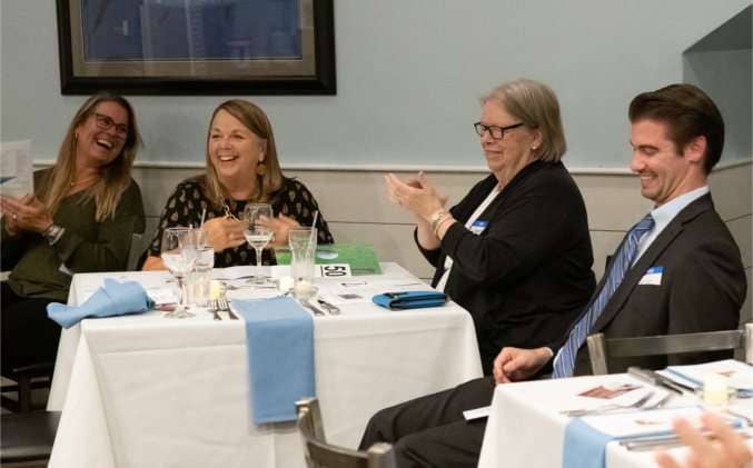Jen Buxton, Judith Ainlay, Janet Doyle, and Matt Reinemann share a laugh.